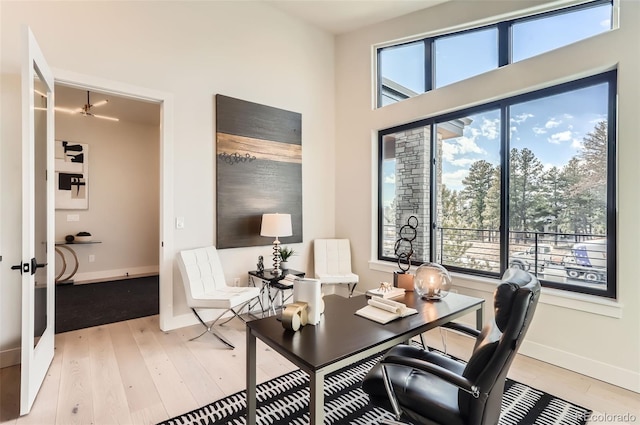 home office featuring light hardwood / wood-style floors and french doors