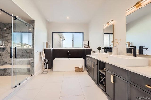 bathroom featuring vanity, tile patterned flooring, and separate shower and tub