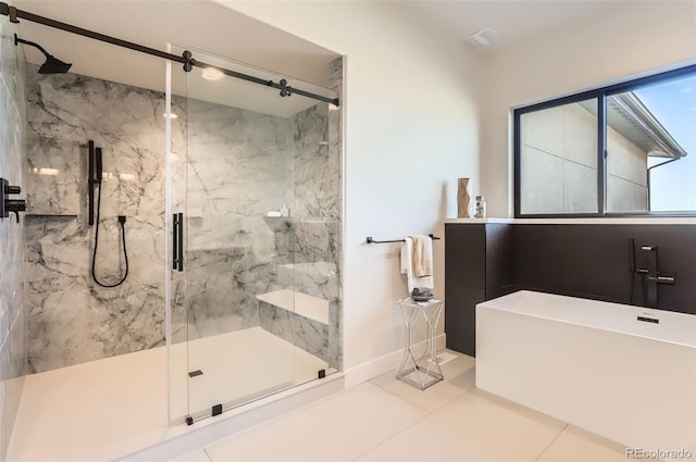 bathroom with tile patterned flooring and a shower with door