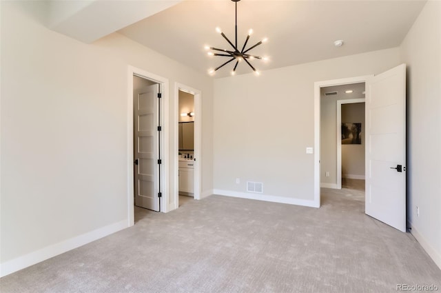 unfurnished bedroom featuring light carpet and a notable chandelier