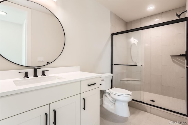 bathroom featuring tile patterned flooring, vanity, walk in shower, and toilet