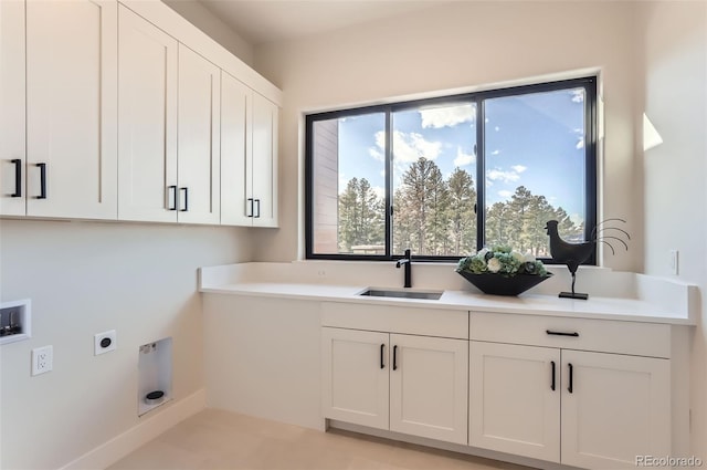 washroom with cabinets, washer hookup, sink, and hookup for an electric dryer