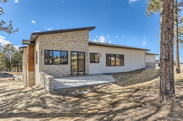 back of house with a patio