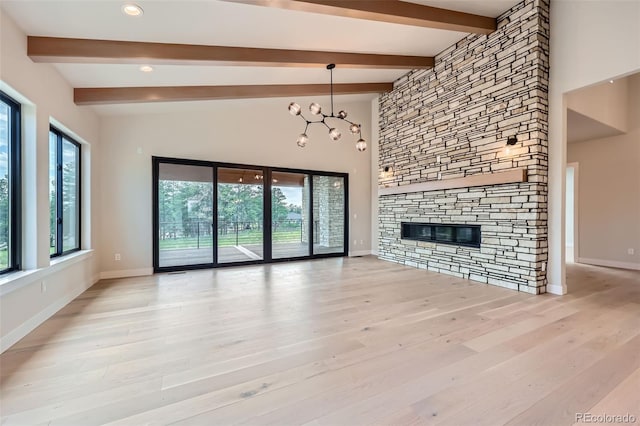 5820 Powell Rd, Parker, CO 80134 - unfurnished living room featuring a fireplace, wood finished floors, recessed lighting, and a chandelier