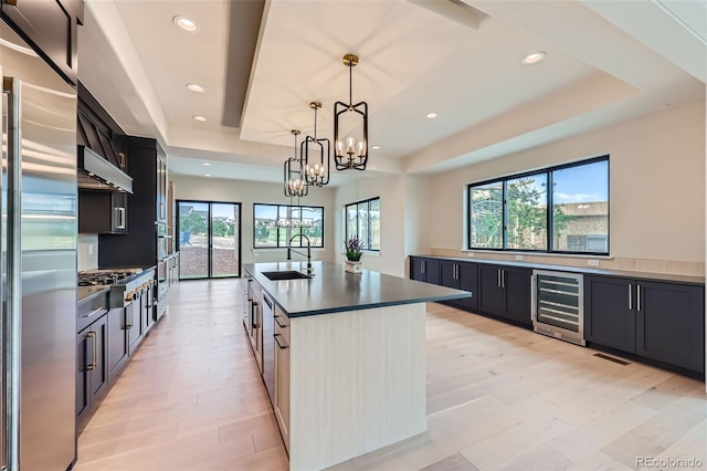 5820 Powell Rd, Parker, CO 80134 - kitchen featuring wine cooler, stainless steel appliances, a tray ceiling, healthy amount of natural light, and recessed lighting