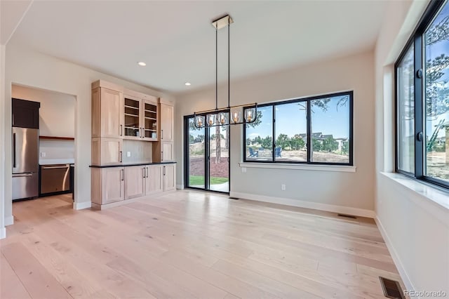 5820 Powell Rd, Parker, CO 80134 - unfurnished living room featuring healthy amount of natural light, light wood finished floors, recessed lighting, and a chandelier