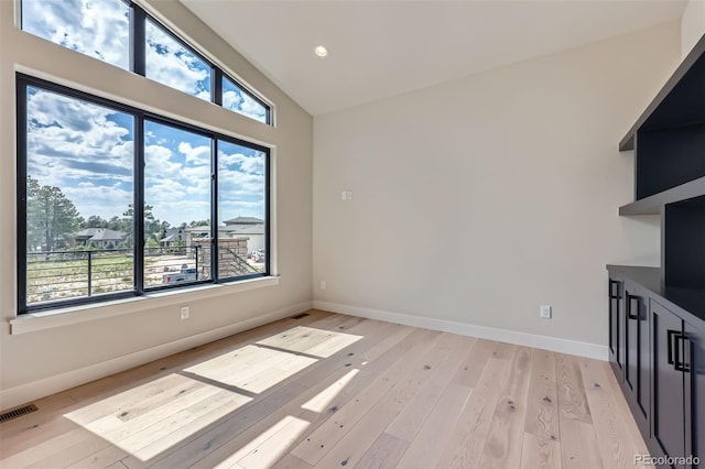 5820 Powell Rd, Parker, CO 80134 - unfurnished living room featuring vaulted ceiling, light wood-style flooring, and recessed lighting