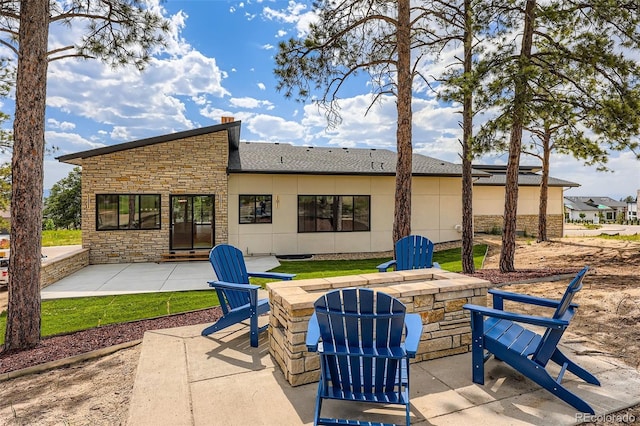 5820 Powell Rd, Parker, CO 80134 - rear view of property featuring stone siding, a patio area, and a fire pit