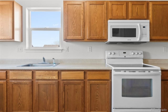 kitchen with white appliances and sink