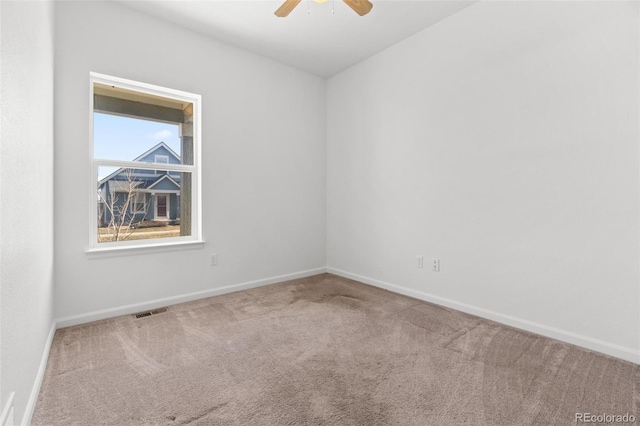 empty room featuring carpet flooring and ceiling fan