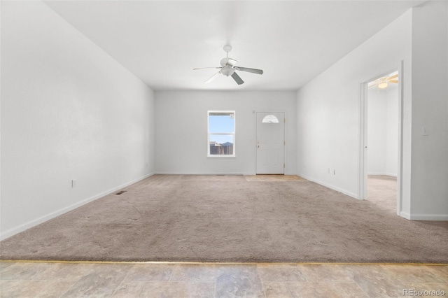 empty room with ceiling fan and light colored carpet