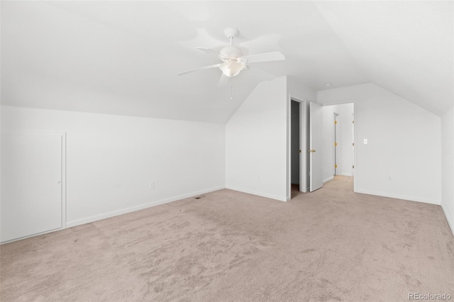 additional living space with ceiling fan, light carpet, and lofted ceiling