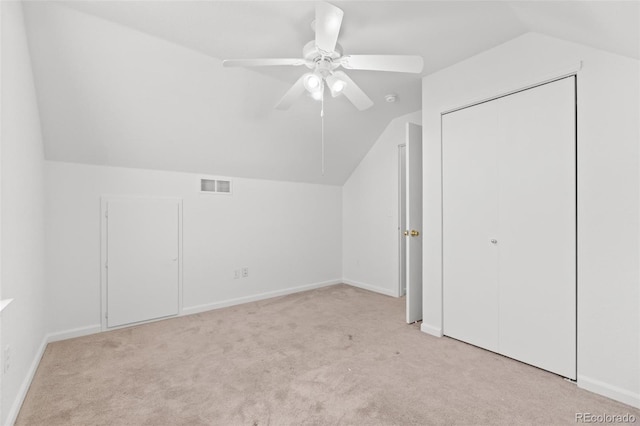 additional living space featuring ceiling fan, light carpet, and lofted ceiling