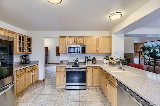 17076 Foxton Dr, Parker, CO 80134 - kitchen with appliances with stainless steel finishes, light countertops, glass insert cabinets, and a sink