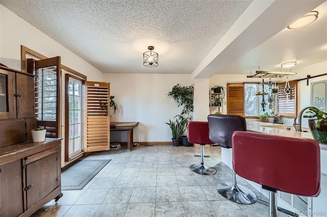 17076 Foxton Dr, Parker, CO 80134 - office featuring plenty of natural light, a textured ceiling, light tile patterned floors, and baseboards