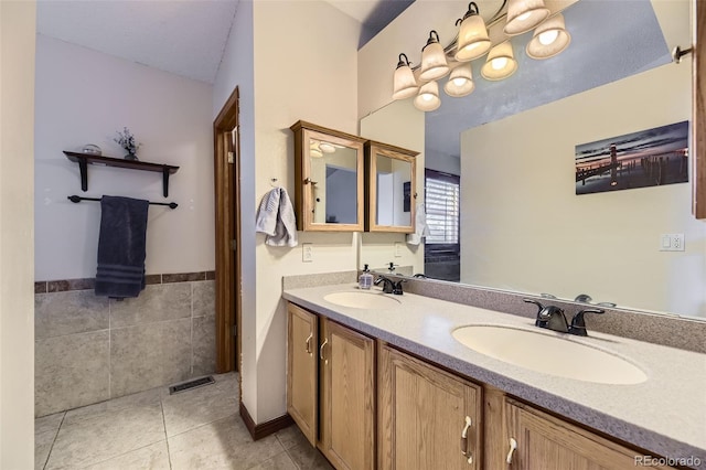 17076 Foxton Dr, Parker, CO 80134 - full bathroom featuring double vanity, tile patterned floors, and tile walls