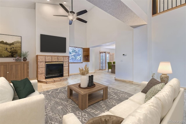 17076 Foxton Dr, Parker, CO 80134 - living area with a towering ceiling, a ceiling fan, a fireplace, and light tile patterned floors