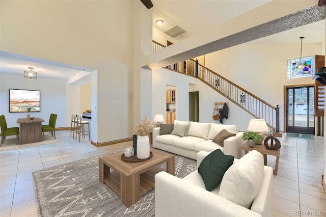 17076 Foxton Dr, Parker, CO 80134 - living area featuring tile patterned flooring, a towering ceiling, and stairway
