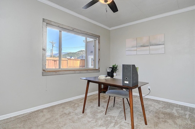 office featuring ceiling fan, light colored carpet, baseboards, and ornamental molding