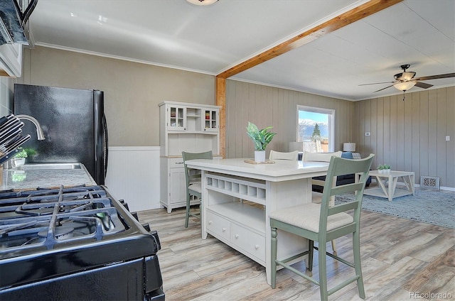 kitchen featuring white cabinets, open shelves, ornamental molding, ceiling fan, and light wood-style flooring