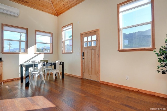 foyer featuring hardwood / wood-style flooring, an AC wall unit, baseboards, and wood ceiling