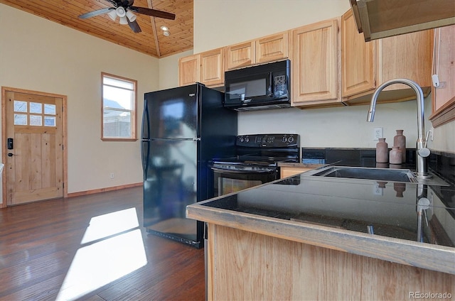 kitchen featuring light brown cabinets, vaulted ceiling, black appliances, ceiling fan, and a sink