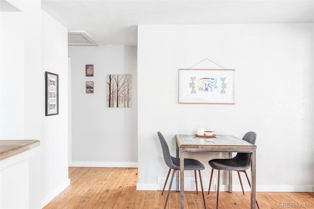 dining area with light hardwood / wood-style flooring