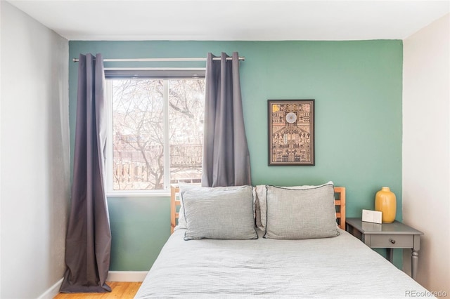 bedroom with hardwood / wood-style flooring