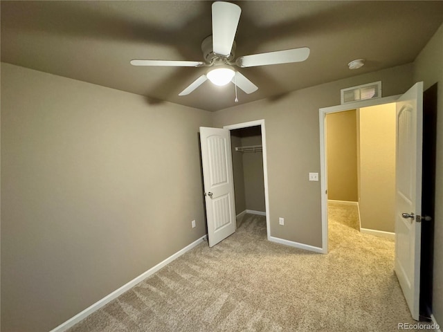 unfurnished bedroom with ceiling fan, a closet, and light carpet