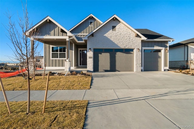 craftsman inspired home with a garage and a front yard