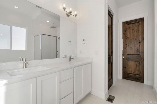 bathroom featuring an enclosed shower and vanity