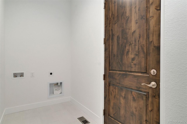 laundry room featuring hookup for an electric dryer, hookup for a washing machine, and light tile patterned floors