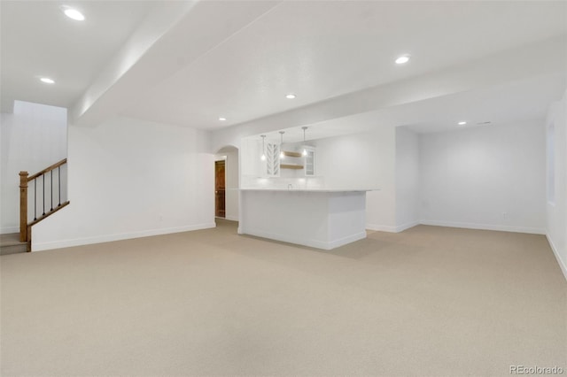 unfurnished living room featuring light colored carpet