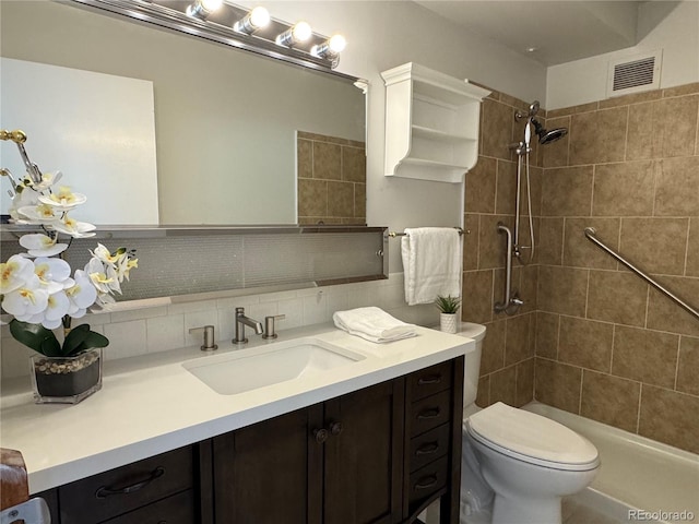 755 S Alton Way Unit 12C, Denver, CO 80247 - bathroom with vanity, toilet, a tile shower, and backsplash