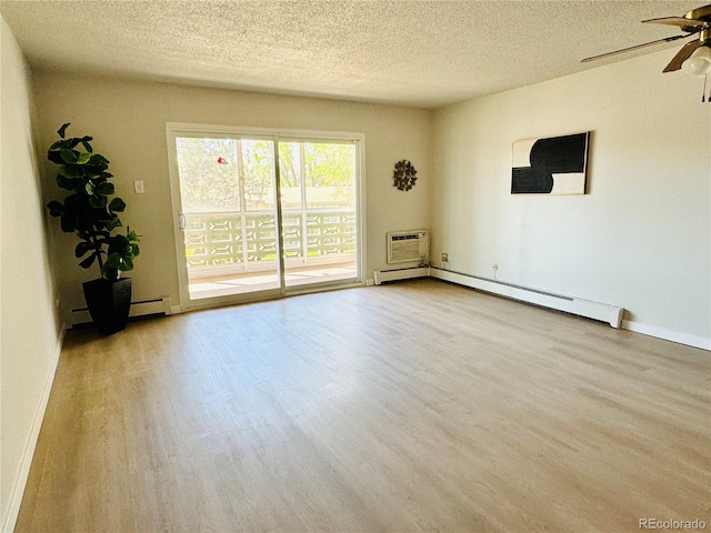 755 S Alton Way Unit 12C, Denver, CO 80247 - unfurnished room featuring a ceiling fan, wood finished floors, a textured ceiling, a baseboard heating unit, and a wall unit AC