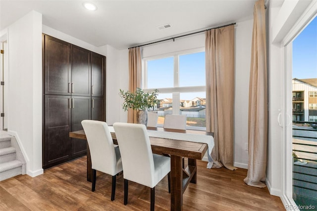 dining area with dark hardwood / wood-style flooring