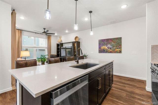 kitchen featuring a center island with sink, ceiling fan, hanging light fixtures, stainless steel dishwasher, and sink