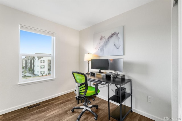 office space with dark wood-type flooring