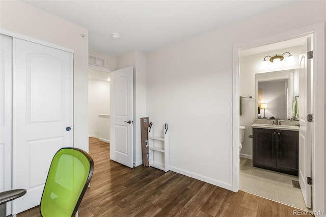 office area with dark wood-type flooring and sink