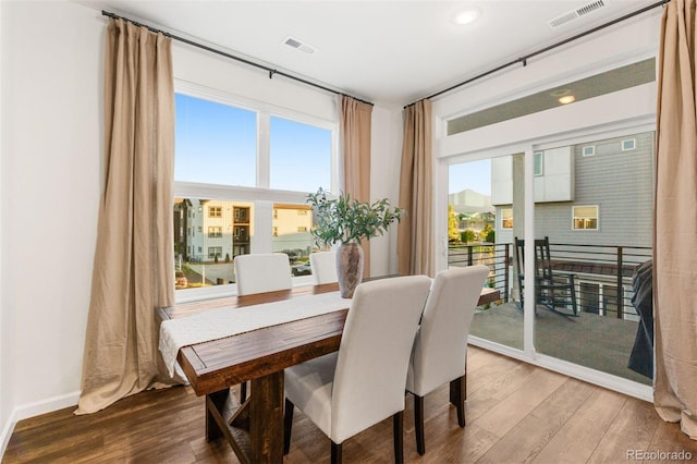 dining area with hardwood / wood-style floors