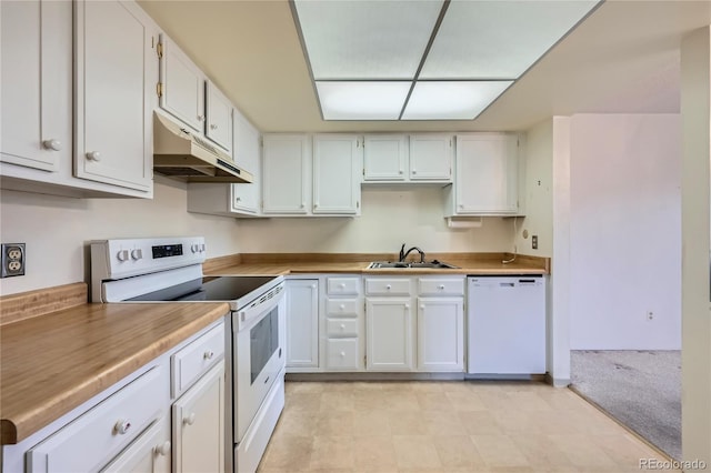 kitchen with under cabinet range hood, white appliances, a sink, and white cabinets