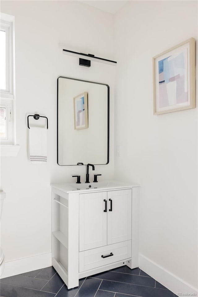 bathroom with vanity, tile patterned flooring, and toilet