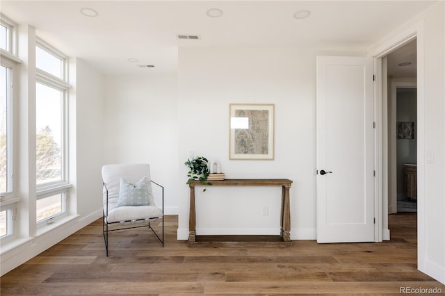 living area with hardwood / wood-style floors