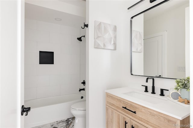 full bathroom featuring toilet, vanity, and tiled shower / bath combo