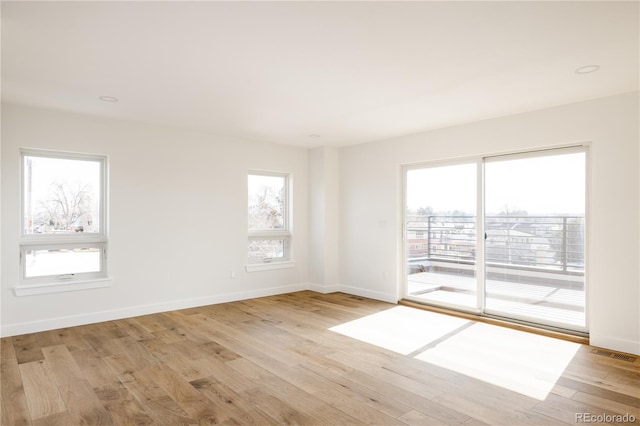 unfurnished room with light wood-type flooring