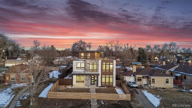 view of back house at dusk