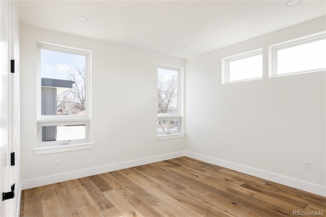 unfurnished room with light hardwood / wood-style flooring and a healthy amount of sunlight