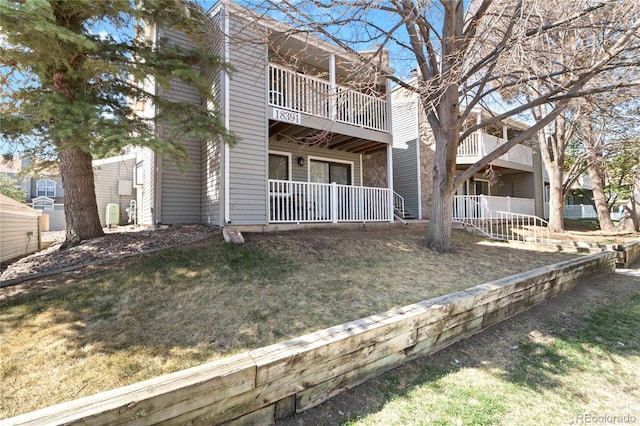 exterior space with a lawn and a balcony