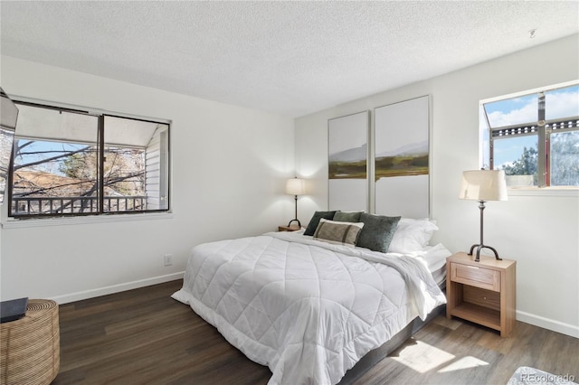 bedroom with baseboards, a textured ceiling, and wood finished floors