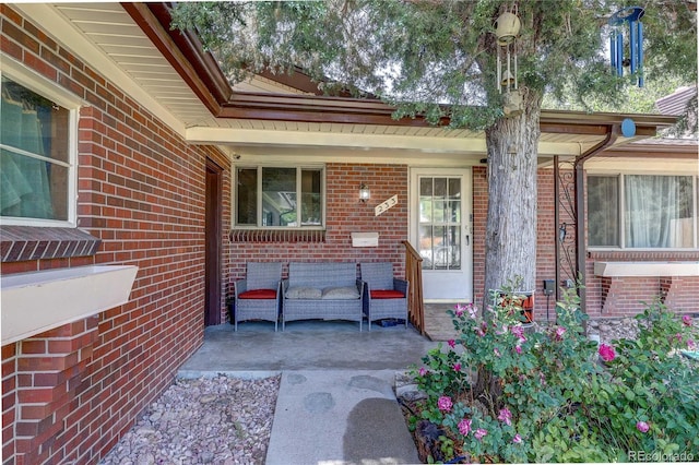 233 Nome St, Aurora, CO 80010 - property entrance featuring covered porch and brick siding